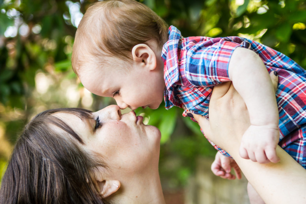 mama kissing baby boy portrait