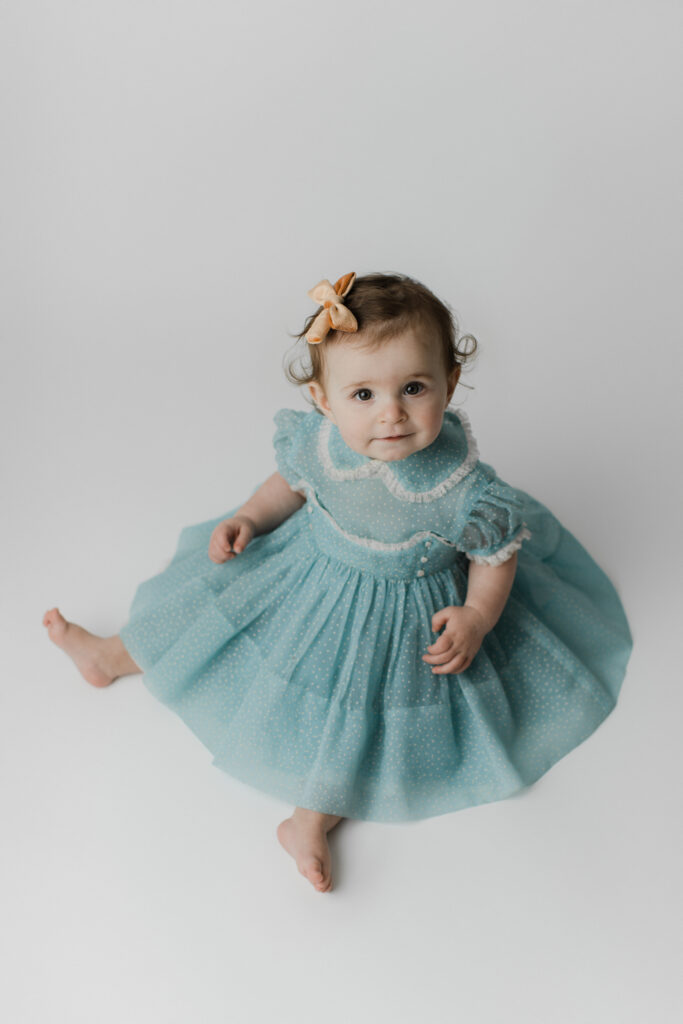 1 year old portrait in blue dress