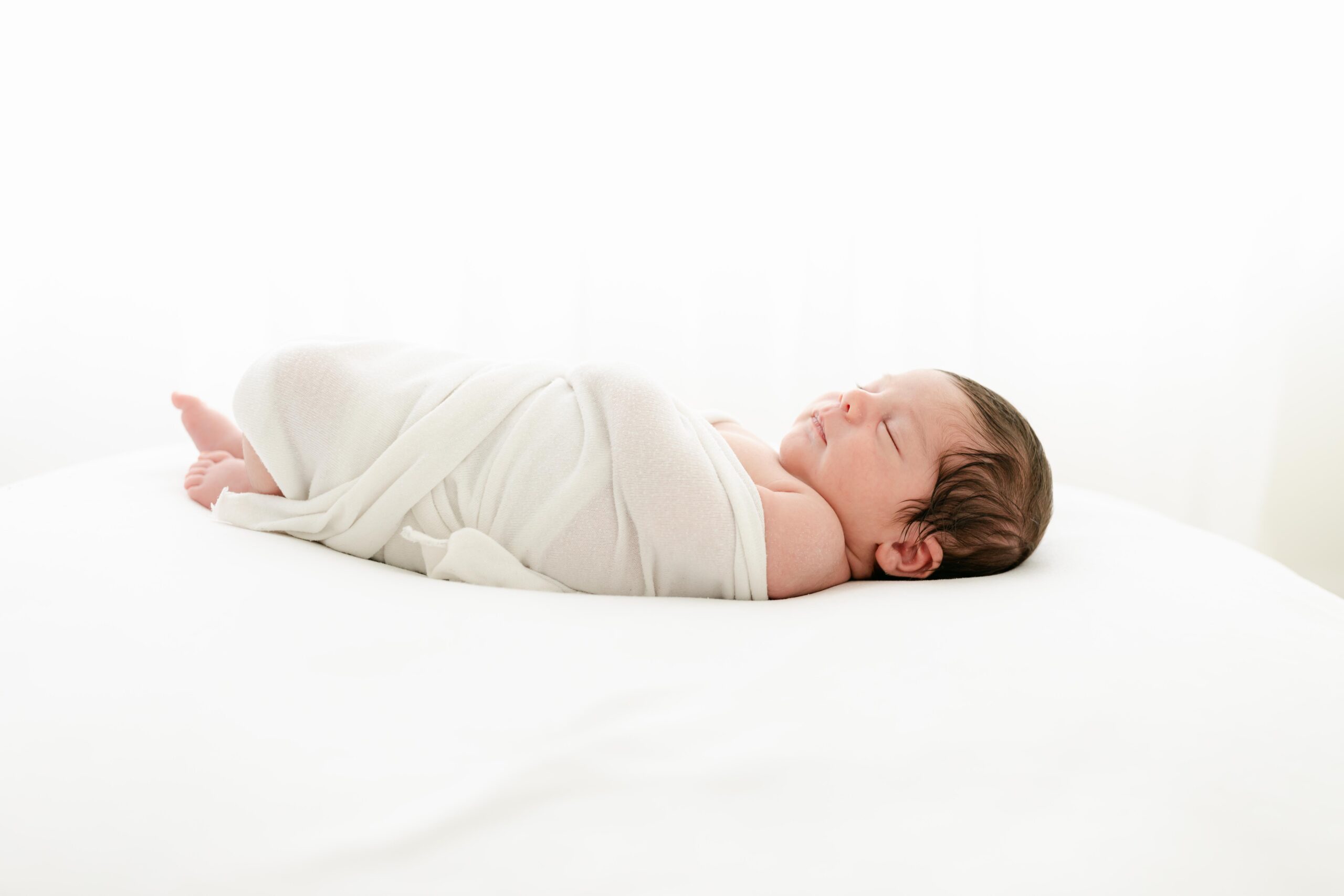 baby boy swaddled in white