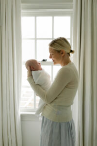 swaddled newborn with mom