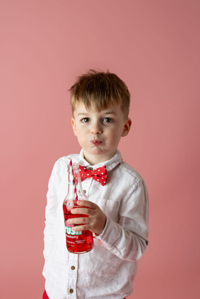 little boy drinking soda