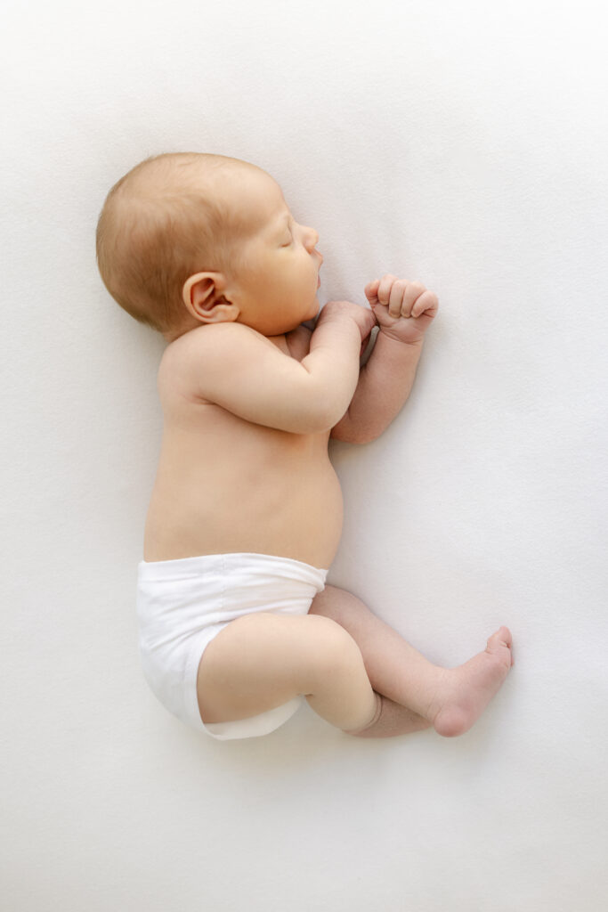 14 day old newborn baby on it's side